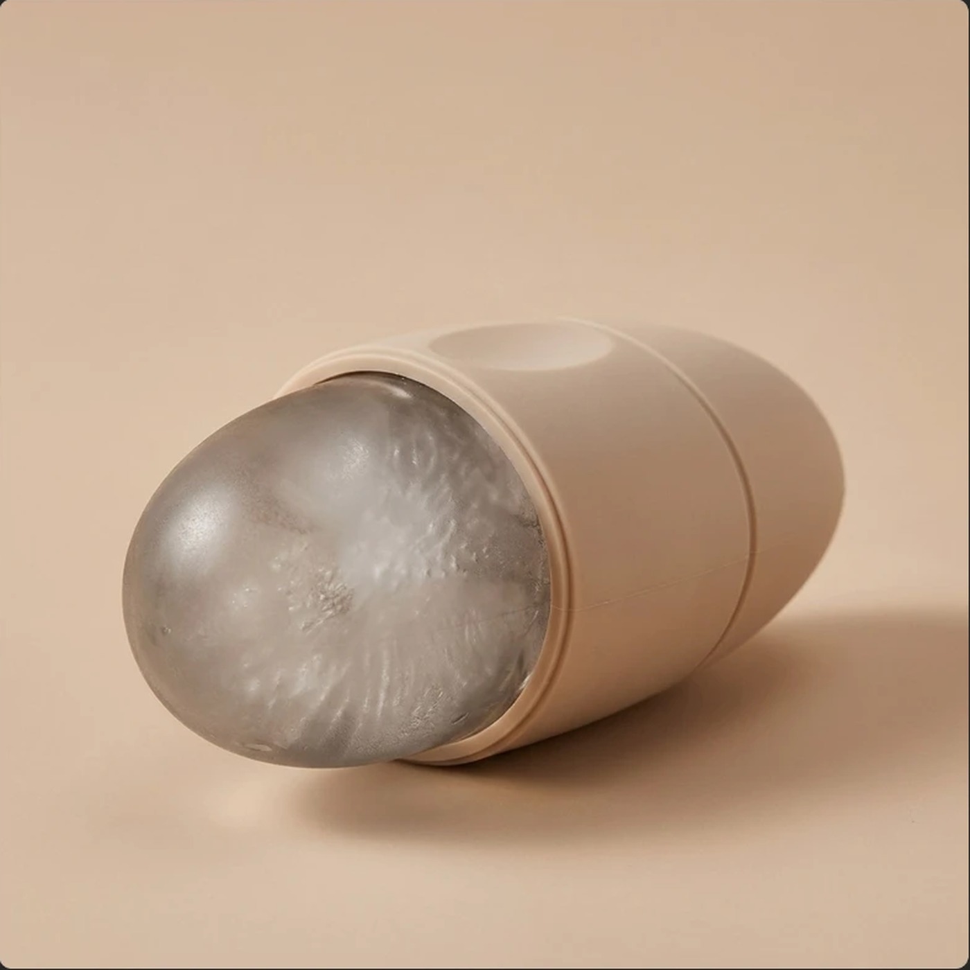 Beige silicone ice face roller with the frozen ice dome exposed